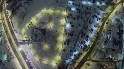 samara square with monument of rocket soyuz and car traffic at winter night